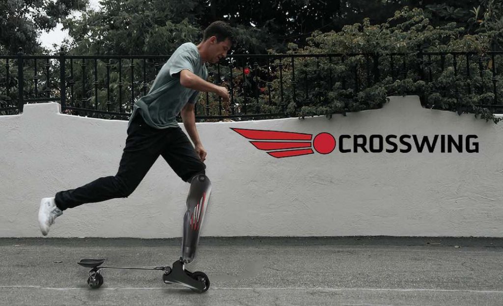 A man with a prosthetic leg that can also be used as a skateboard on a street. Text: Crosswing